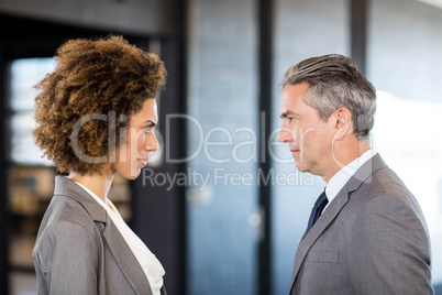 Businessman and businesswoman standing face to face