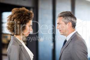 Businessman and businesswoman standing face to face