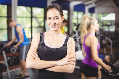 Smiling woman posing with arms crossed