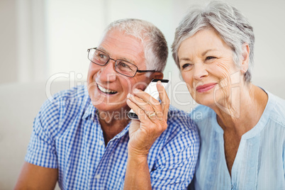 Senior couple talking on mobile phone