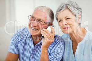 Senior couple talking on mobile phone