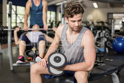 Fit man lifting dumbbell