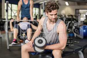 Fit man lifting dumbbell