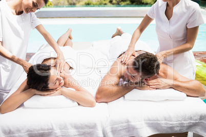 Young couple receiving a back massage from masseur