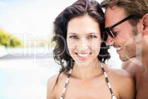 Young couple embracing each other near pool