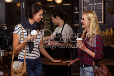 Smiling friends enjoying coffee