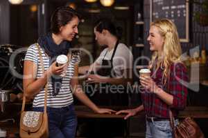 Smiling friends enjoying coffee