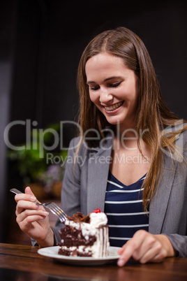 Smiling woman about to eat cake