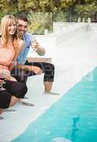 Young couple enjoying near poolside