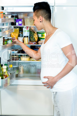 Pregnant woman looking in fridge