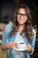 Smiling brunette drinking a coffee