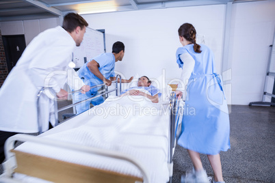 Doctors standing near patient bed