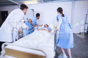 Doctors standing near patient bed
