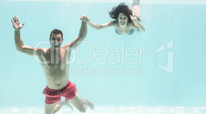 Couple enjoying underwater in swimming pool