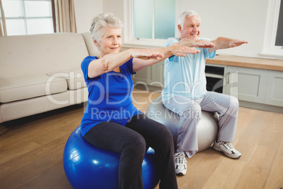 Senior couple exercising on exercise ball Senior couple exercising on exercise ball