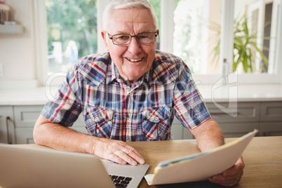 Happy senior man using laptop