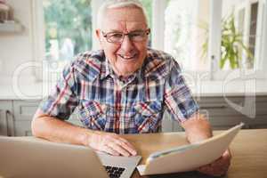 Happy senior man using laptop