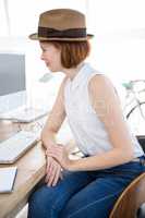 smiling hipster business woman looking at her computer