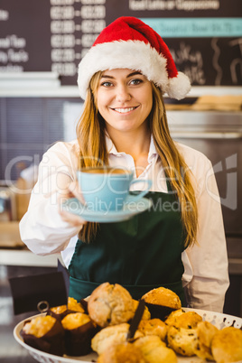 Cute waitress standing behind the counter