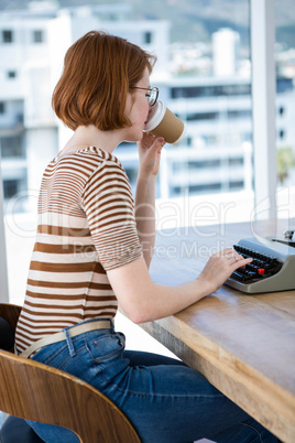 hipster business woman drinking a cup of coffee