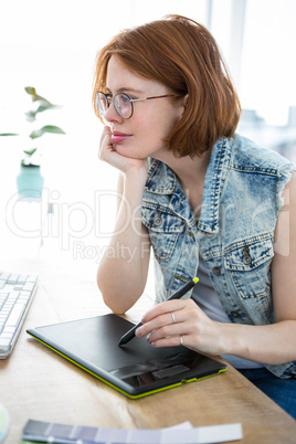 hipster woman writing on a digital drawing tablet