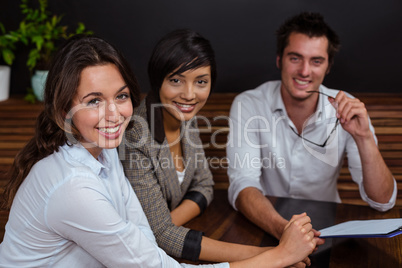 Smiling friends holding the menu