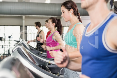 Women and men running on a treadmill