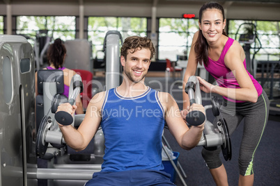 Trainer woman helping athletic man Trainer woman helping athletic man