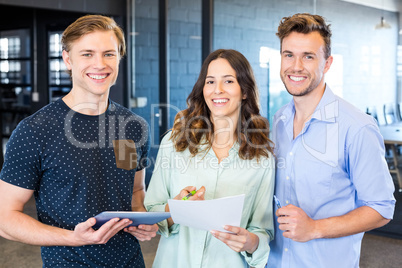 Three confident colleagues discussing in office