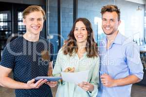 Three confident colleagues discussing in office