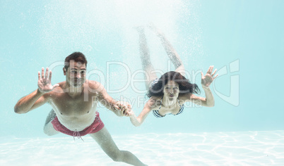 Couple enjoying underwater in swimming pool