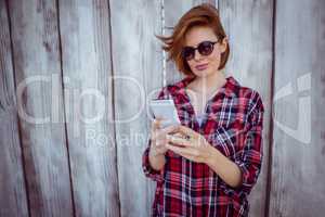 smiling hipster woman on her smartphone