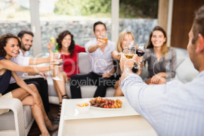 Group of friends toasting cocktail drinks