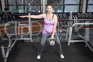 Pregnant woman lifting kettlebell