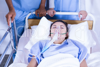 Patient with oxygen mask lying on bed