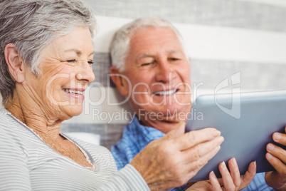 Senior couple using digital tablet