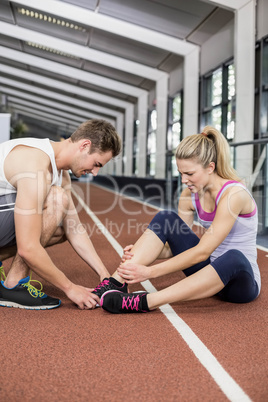 Muscular woman having an ankle injury