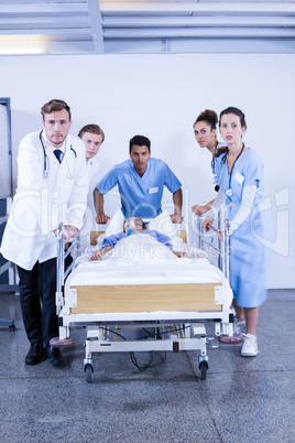 Concerned doctors standing near patient on bed