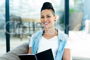 portrait of pregnant woman writing on notepad