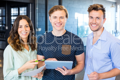 Three confident colleagues discussing in office