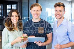 Three confident colleagues discussing in office