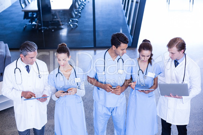 Medical team using laptop, mobile and digital tablet