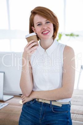 smiling hipster woman holding a coffee cup