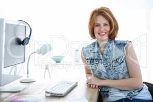smiling hipster woman sitting at a desk