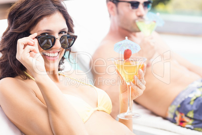 Young couple sitting on sun loungers