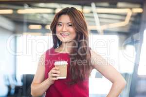 Beautiful young woman having coffee