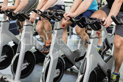 Fit group of people using exercise bike together