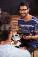 Smiling friends enjoying coffee together