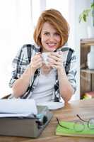 smiling hipster woman drinking a  cup of coffee