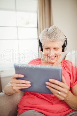 Happy senior woman listening to music